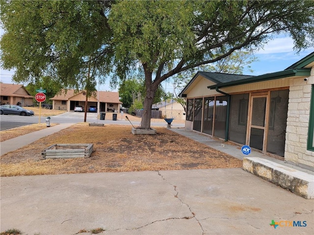 view of yard with a sunroom