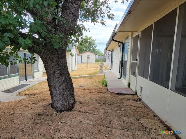 view of yard featuring a sunroom