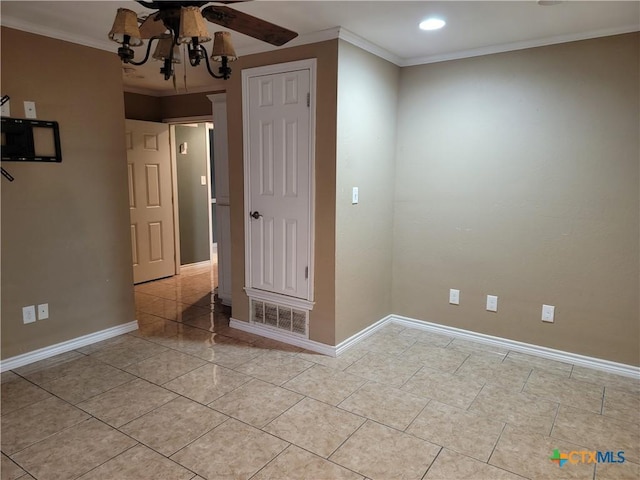 unfurnished bedroom featuring ceiling fan with notable chandelier, light tile patterned floors, and crown molding