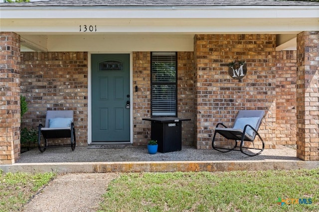 1301 Chapel Creek Rd, Waco, TX 76712 - entrance to property featuring brick siding, a porch, and roof with shingles