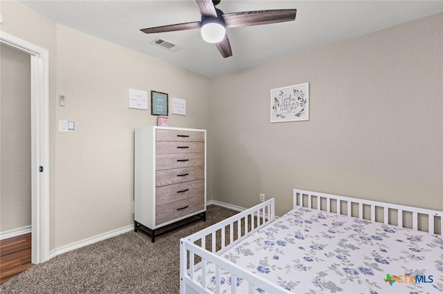 1301 Chapel Creek Rd, Waco, TX 76712 - bedroom with dark colored carpet, baseboards, and ceiling fan