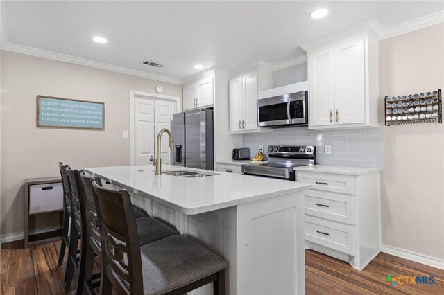 1301 Chapel Creek Rd, Waco, TX 76712 - kitchen featuring stainless steel appliances, baseboards, a kitchen bar, tasteful backsplash, and dark wood-style floors