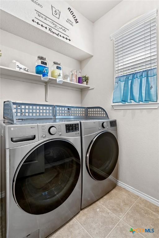 6804 Bayberry Dr, Killeen, TX 76542 - laundry area with separate washer and dryer and tile patterned flooring