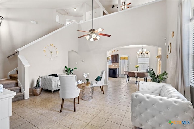 6804 Bayberry Dr, Killeen, TX 76542 - living room with ceiling fan, arched walkways, light tile patterned floors, high vaulted ceiling, and stairs