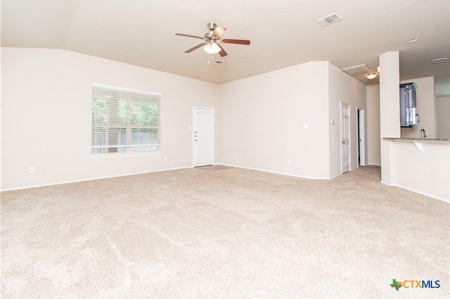 7010 Cokui Dr, Killeen, TX 76542 - unfurnished living room with ceiling fan, light colored carpet, and lofted ceiling