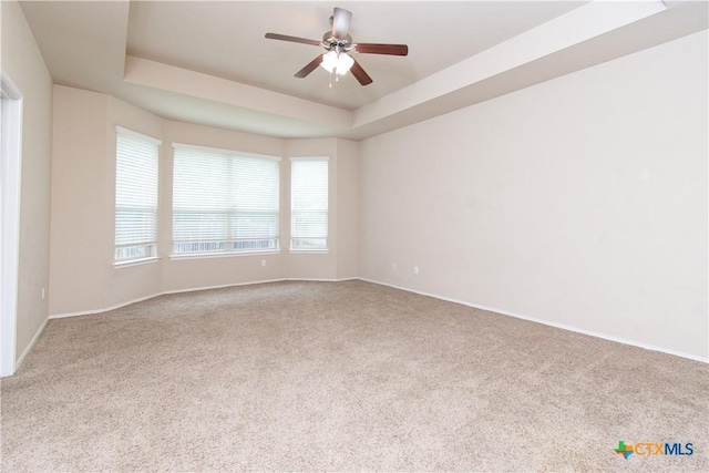 7010 Cokui Dr, Killeen, TX 76542 - spare room featuring carpet, a tray ceiling, and ceiling fan