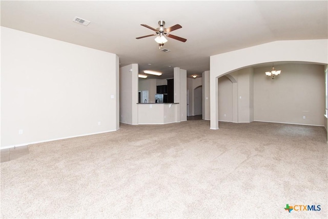 7010 Cokui Dr, Killeen, TX 76542 - unfurnished living room with arched walkways, a chandelier, ceiling fan, and carpet flooring
