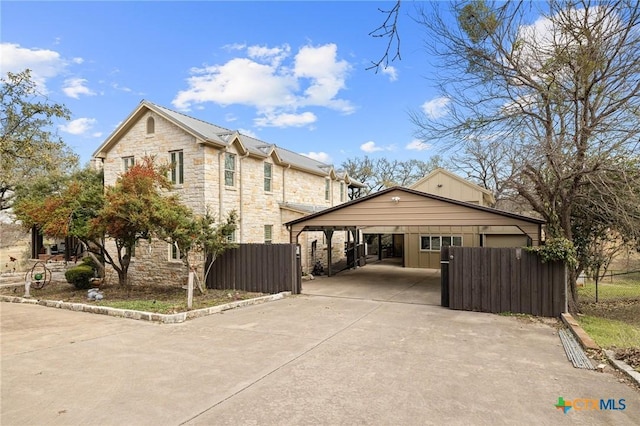913 Southridge Rd, Salado, TX 76571 - view of property exterior with stone siding, driveway, and a carport