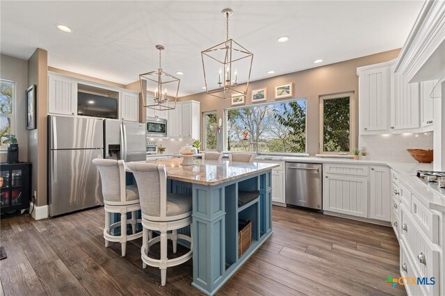 913 Southridge Rd, Salado, TX 76571 - kitchen with stainless steel appliances, white cabinets, backsplash, recessed lighting, and a chandelier