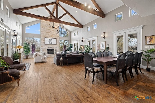 913 Southridge Rd, Salado, TX 76571 - dining area featuring high vaulted ceiling, wood finished floors, a fireplace, and beam ceiling