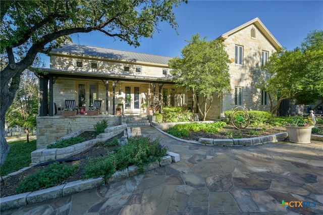 913 Southridge Rd, Salado, TX 76571 - view of front facade with french doors, stone siding, a porch, and a metal roof