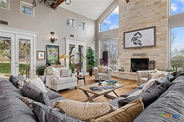 913 Southridge Rd, Salado, TX 76571 - living area with high vaulted ceiling, wood finished floors, healthy amount of natural light, and french doors