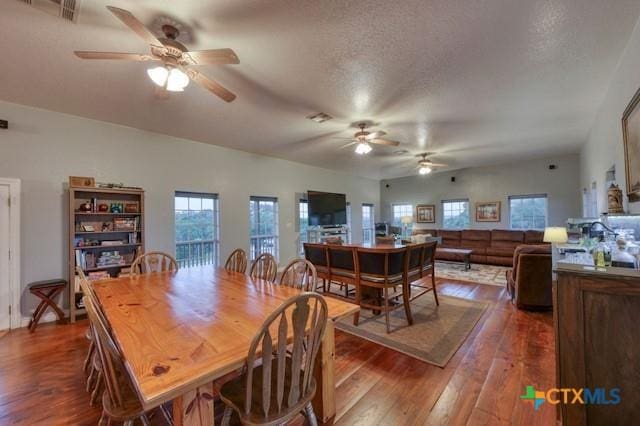 dining room with dark hardwood / wood-style flooring and a textured ceiling