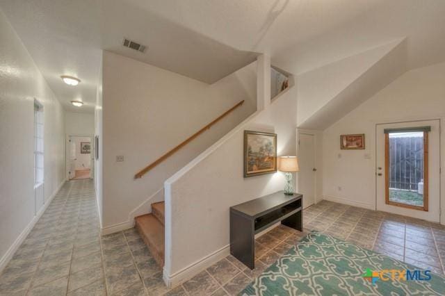 foyer entrance featuring tile patterned flooring and lofted ceiling