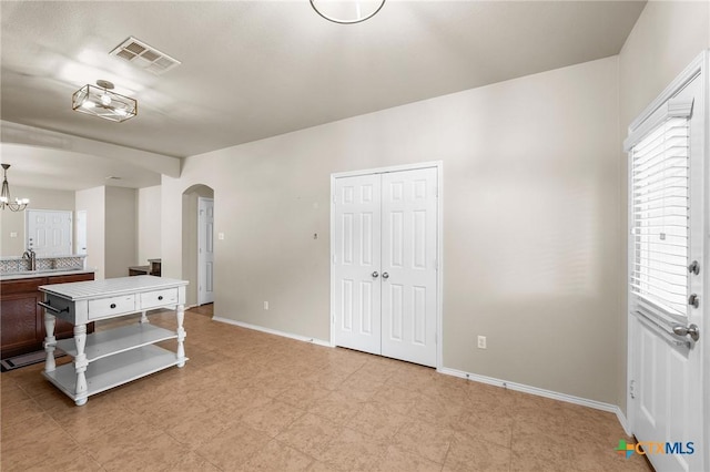 824 Starlight Dr, Temple, TX 76502 - bedroom with arched walkways, baseboards, a chandelier, and a closet