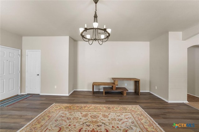 824 Starlight Dr, Temple, TX 76502 - unfurnished dining area with wood finished floors, a chandelier, baseboards, and arched walkways