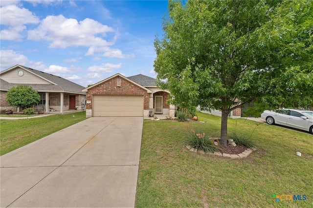824 Starlight Dr, Temple, TX 76502 - view of front of home with brick siding, a garage, driveway, and a front yard