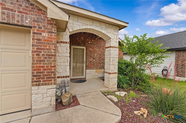 824 Starlight Dr, Temple, TX 76502 - view of exterior entry featuring brick siding, stone siding, and a garage