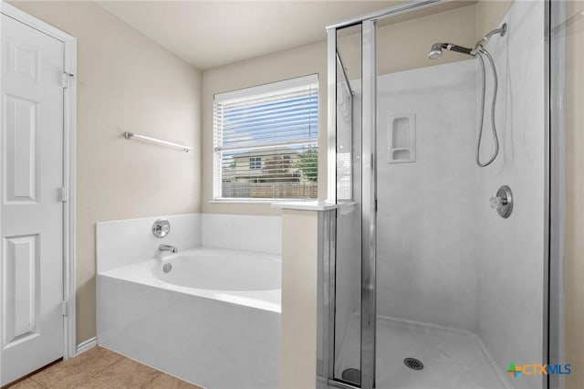 824 Starlight Dr, Temple, TX 76502 - bathroom with a shower stall, tile patterned flooring, and a bath