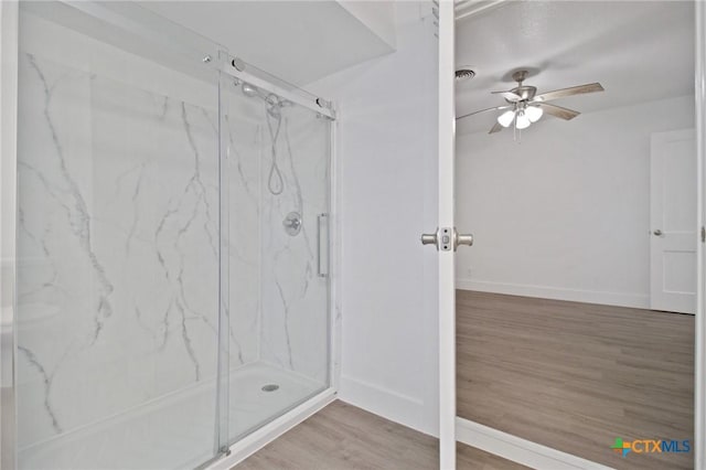 542 Williamsburg Pl, San Antonio, TX 78201 - bathroom featuring ceiling fan, wood finished floors, a marble finish shower, and baseboards