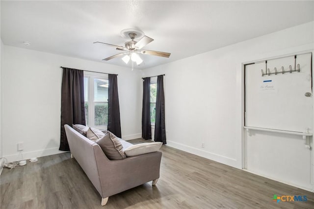 542 Williamsburg Pl, San Antonio, TX 78201 - living room with light wood-style floors, a ceiling fan, and baseboards