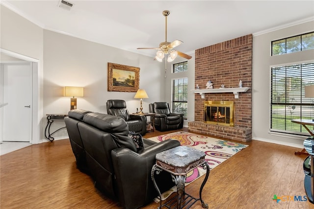 1207 Old Homestead, Seguin, TX 78155 - living room with ornamental molding, ceiling fan, wood finished floors, and a fireplace