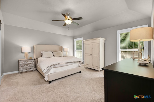 carpeted bedroom featuring multiple windows and ceiling fan