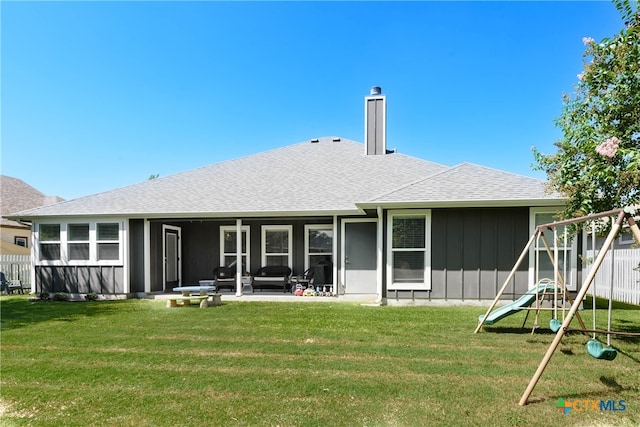 back of house with a yard and a patio area