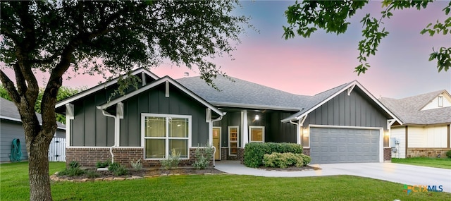 craftsman-style home with a garage and a yard