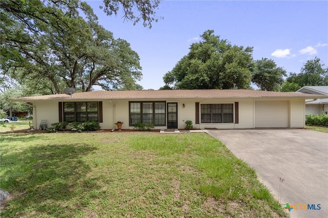 ranch-style house featuring a garage and a front yard