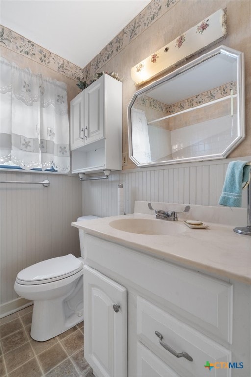 bathroom featuring vanity and toilet