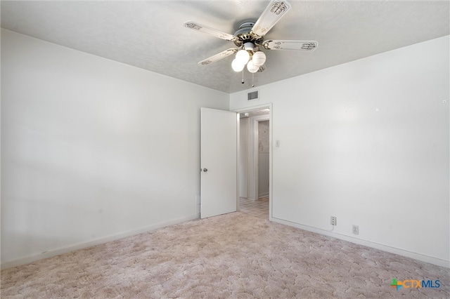 empty room with ceiling fan and light colored carpet