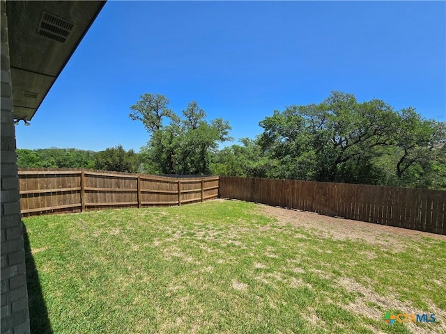 view of yard with a fenced backyard
