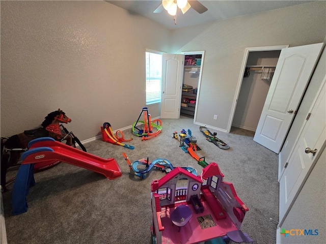 rec room with a ceiling fan, lofted ceiling, baseboards, and carpet flooring