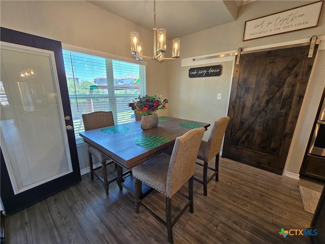dining space with a barn door, dark wood-style flooring, and a notable chandelier