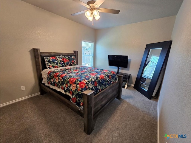 bedroom featuring baseboards, ceiling fan, and carpet