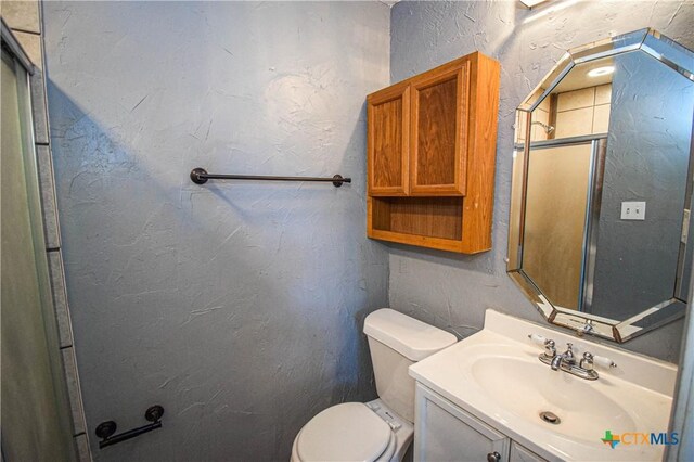 202 Margaret Lee St, Copperas Cove, TX 76522 - full bathroom featuring vanity, a shower with door, and a textured wall