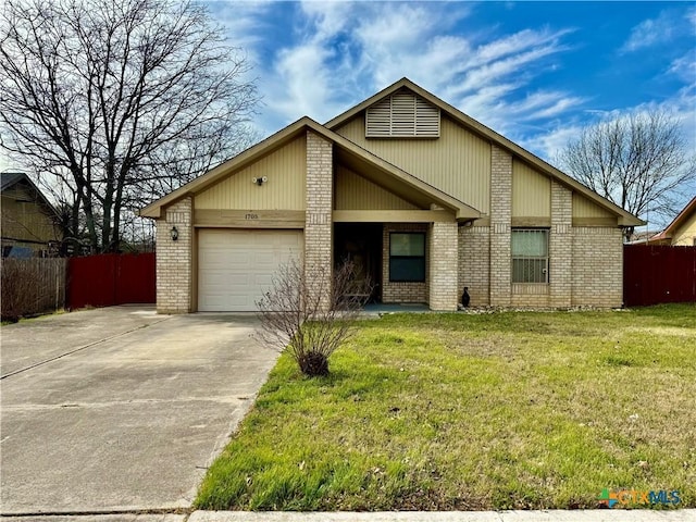 view of front of house featuring a garage, concrete driveway, fence, a front yard, and brick siding