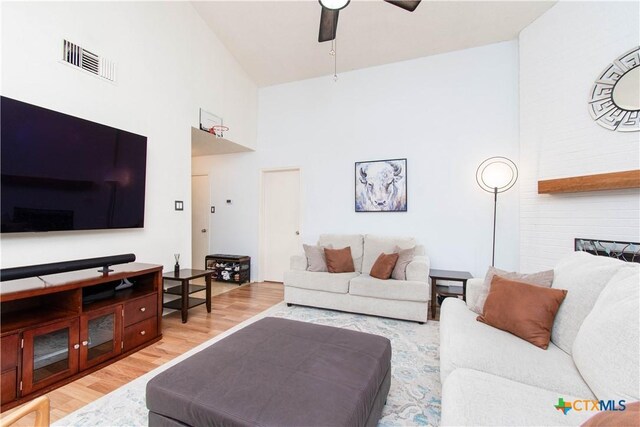 dining area featuring vaulted ceiling, a textured ceiling, wood finished floors, and baseboards