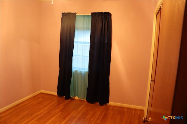 spare room with wood-type flooring