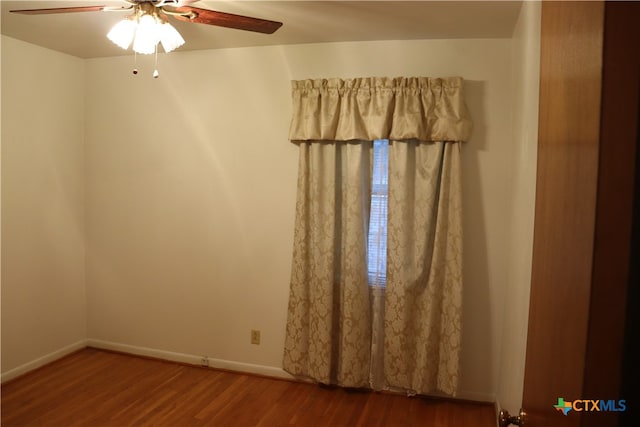 spare room with ceiling fan and hardwood / wood-style flooring