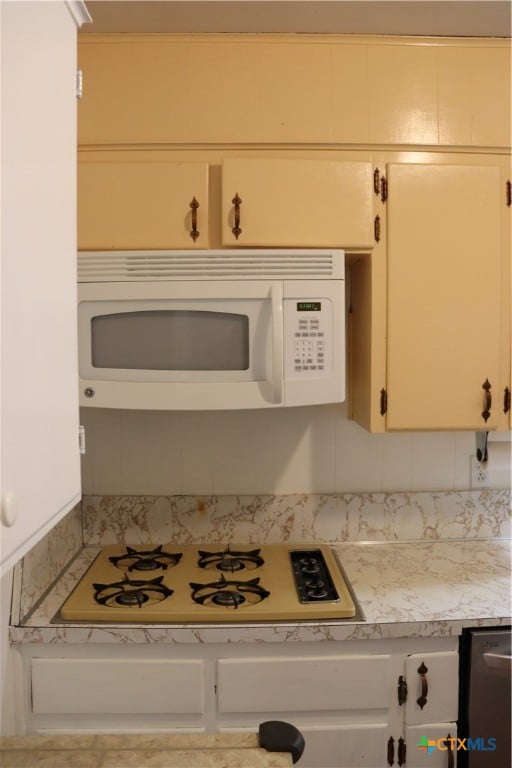 interior space featuring white cabinets and white appliances