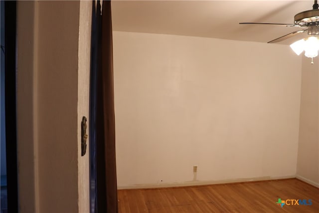 empty room with hardwood / wood-style floors and ceiling fan