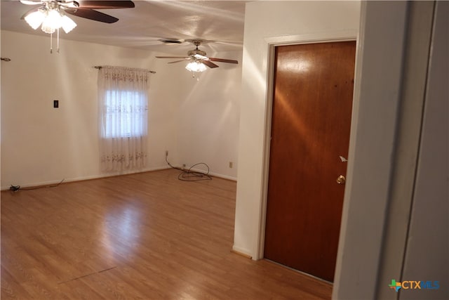 spare room featuring wood-type flooring and ceiling fan