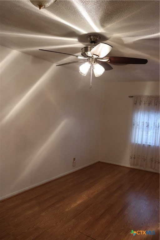 unfurnished room featuring a textured ceiling, ceiling fan, and dark hardwood / wood-style floors