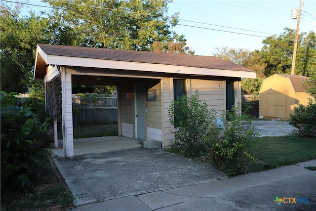 view of outbuilding with a lawn and a carport