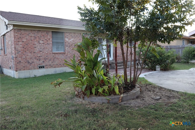 view of home's exterior featuring a yard and a patio area