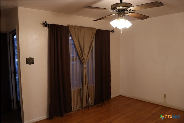 unfurnished room featuring hardwood / wood-style flooring and ceiling fan