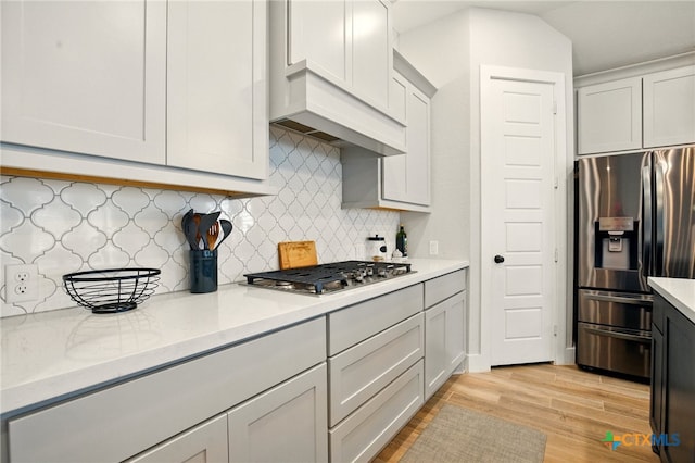 1911 Peres St, New Braunfels, TX 78132 - kitchen with stainless steel appliances, light wood finished floors, and backsplash