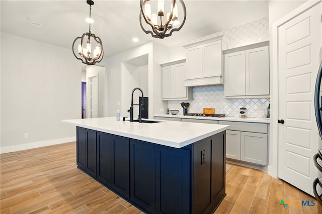 1911 Peres St, New Braunfels, TX 78132 - kitchen with a sink, a chandelier, recessed lighting, light wood-style floors, and light countertops